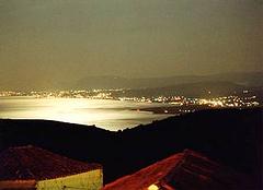 Moonlit bay of Chania, light speckled coastline from Maleme to Chania. Xania.