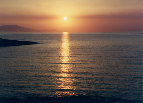 Wine dark sea.  Bay of Chania. Sun setting over Rodopos peninsula, North Western Crete.